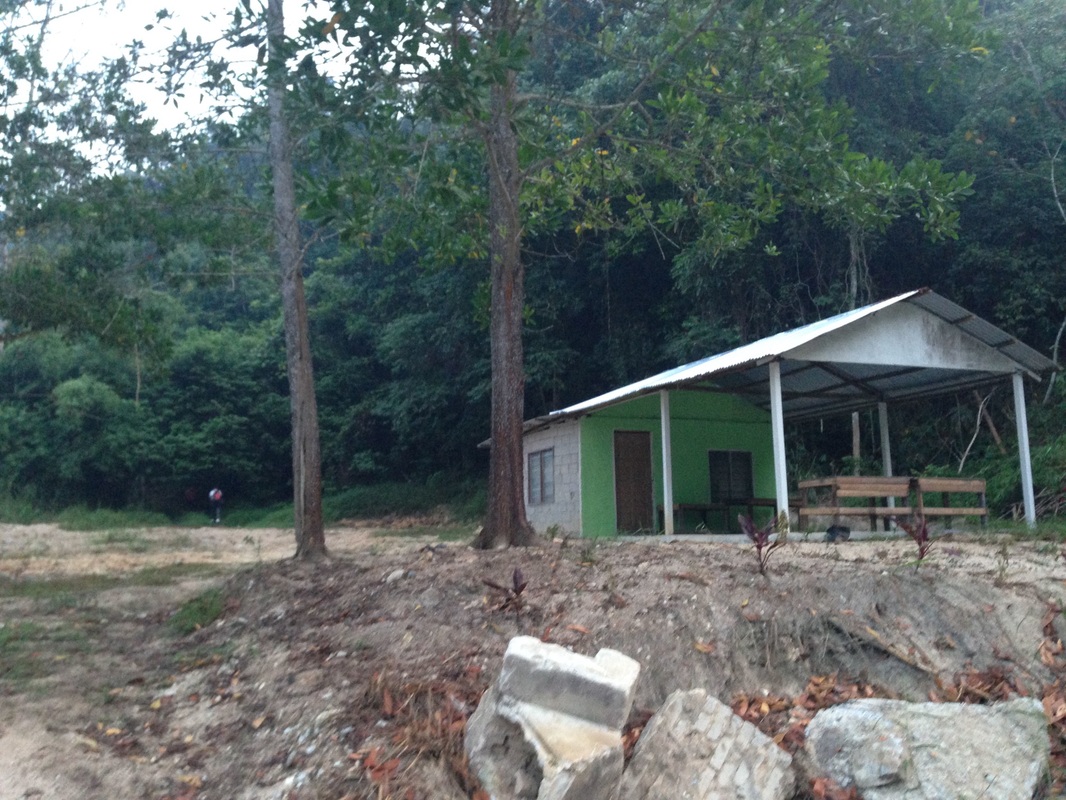 The canteen-like building at the start of the trail. The trailhead can be seen as a break in the foliage at the back