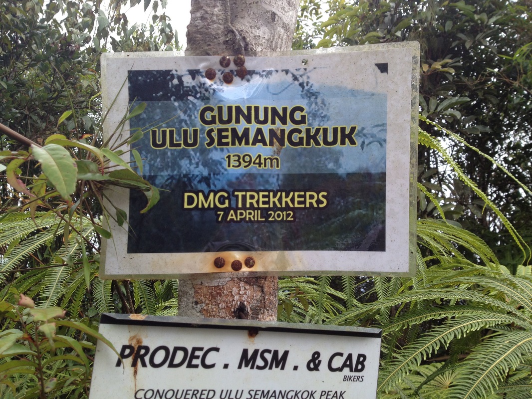 The laminated paper signboard at the peak of Gunung Ulu Semangkok