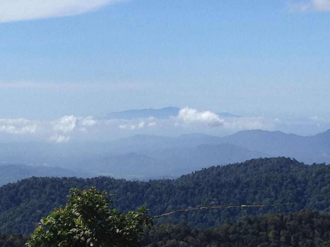 View from the top towards the southeast. The mountain peaking above the clouds in the far background is supposedly Gunung Ledang! Jalan Kuala Pilah can be seen as a hazy grey line in the middle ground