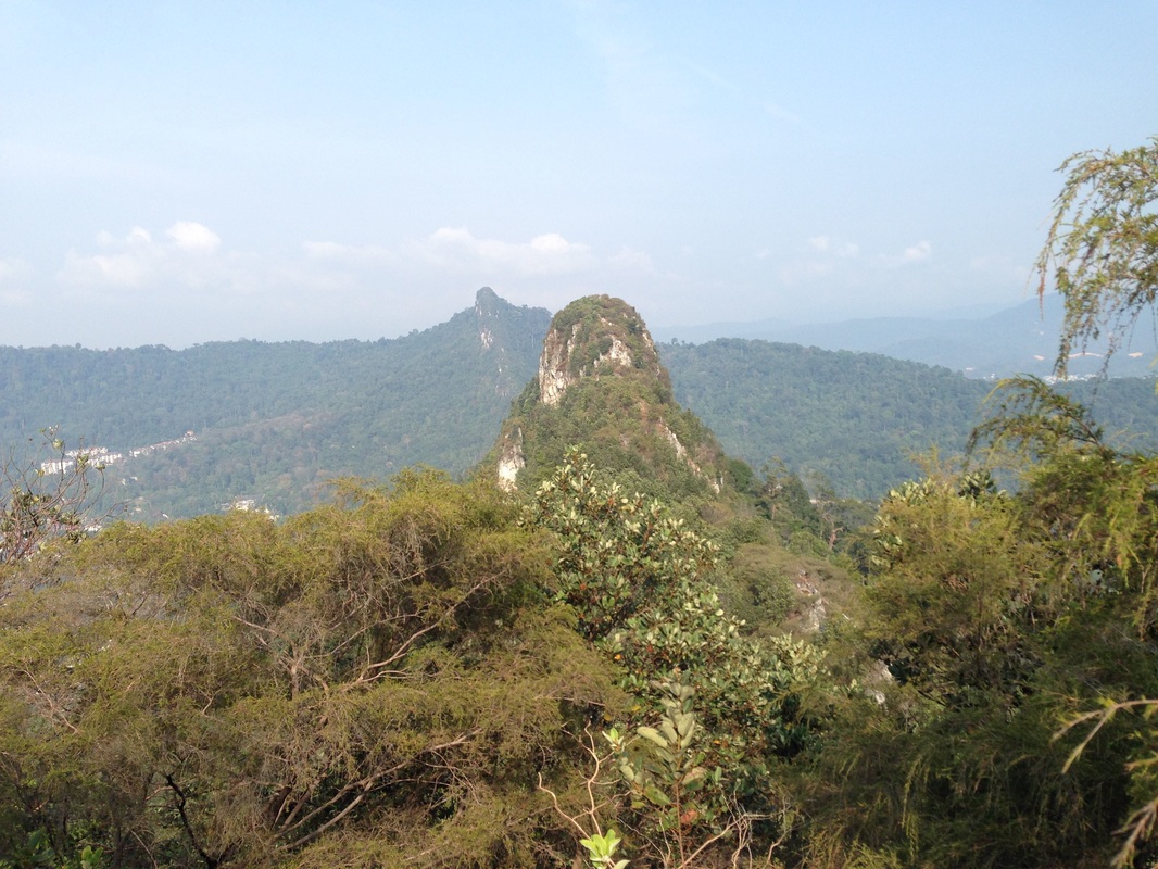 The pinnacle in front is that of Tabur East. Further at the back are the peaks of Tabur West. The peaks make a clear straight line cutting through forests of Hulu Kelang