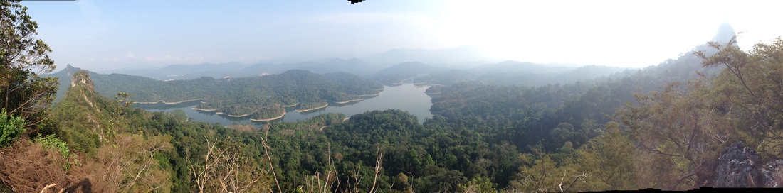 180 degree panorama taken from the top of Tabur Far East peak #2 (highest). On the left are the peaks of Tabur West (far away) and Tabur East. In front are the Klang Gates Reservoir. On the right is the peak of Tabur Extreme. The highlands of the Titiwangsa are not clearly visible due to the hazy conditions