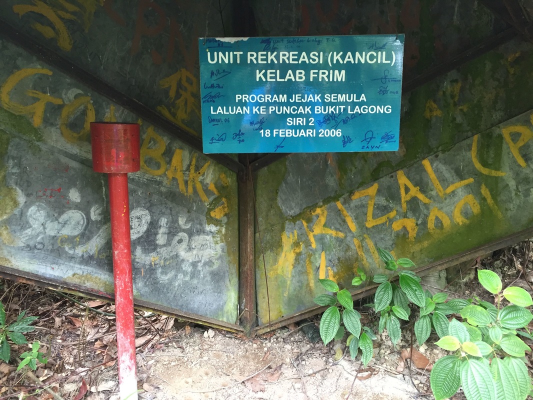 The plaque inside the metal structure at the Lagong peak